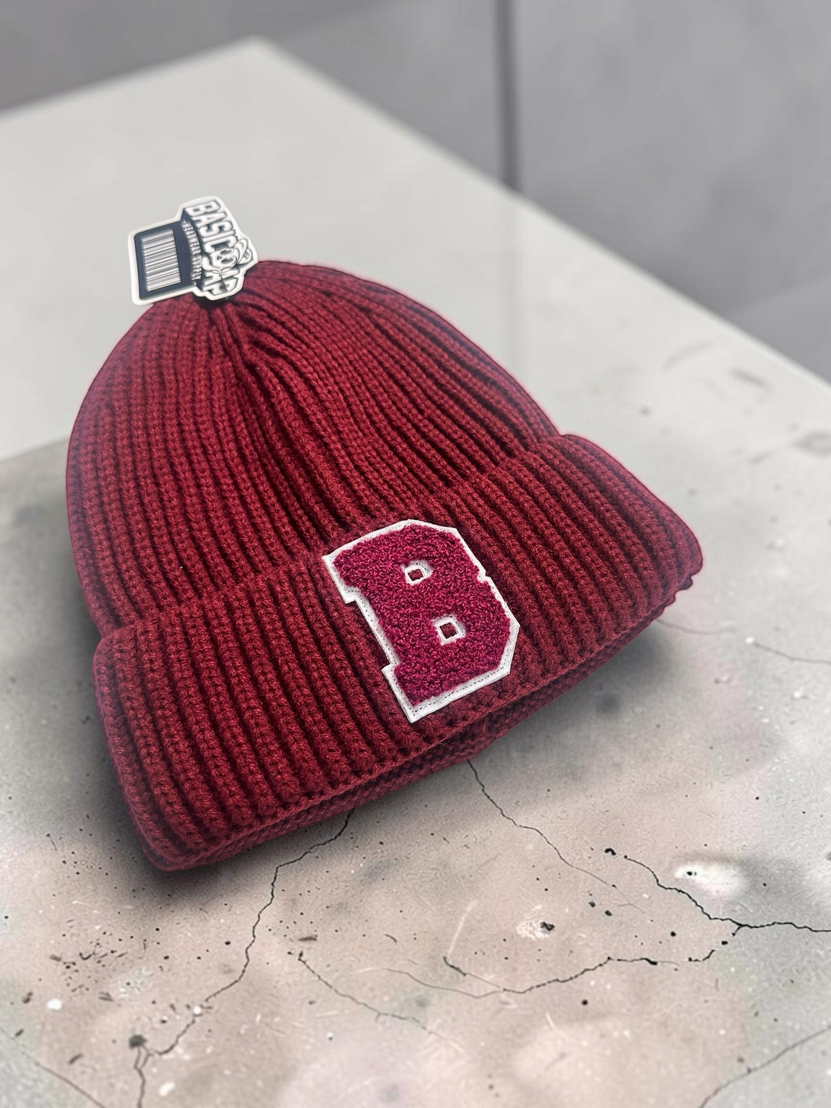 B-Is-TheBrand burgundy ribbed knit cuffed beanie with a textured varsity-style letter B patch on the front.