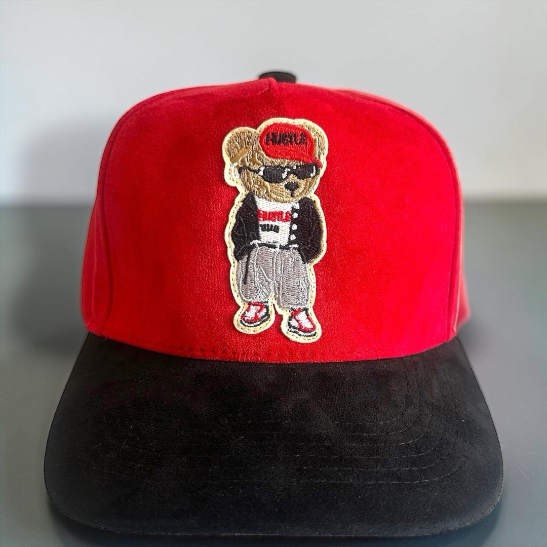 B-Is-TheBrand Hustle Bear baseball cap with a red crown, black brim, and embroidered urban bear patch.