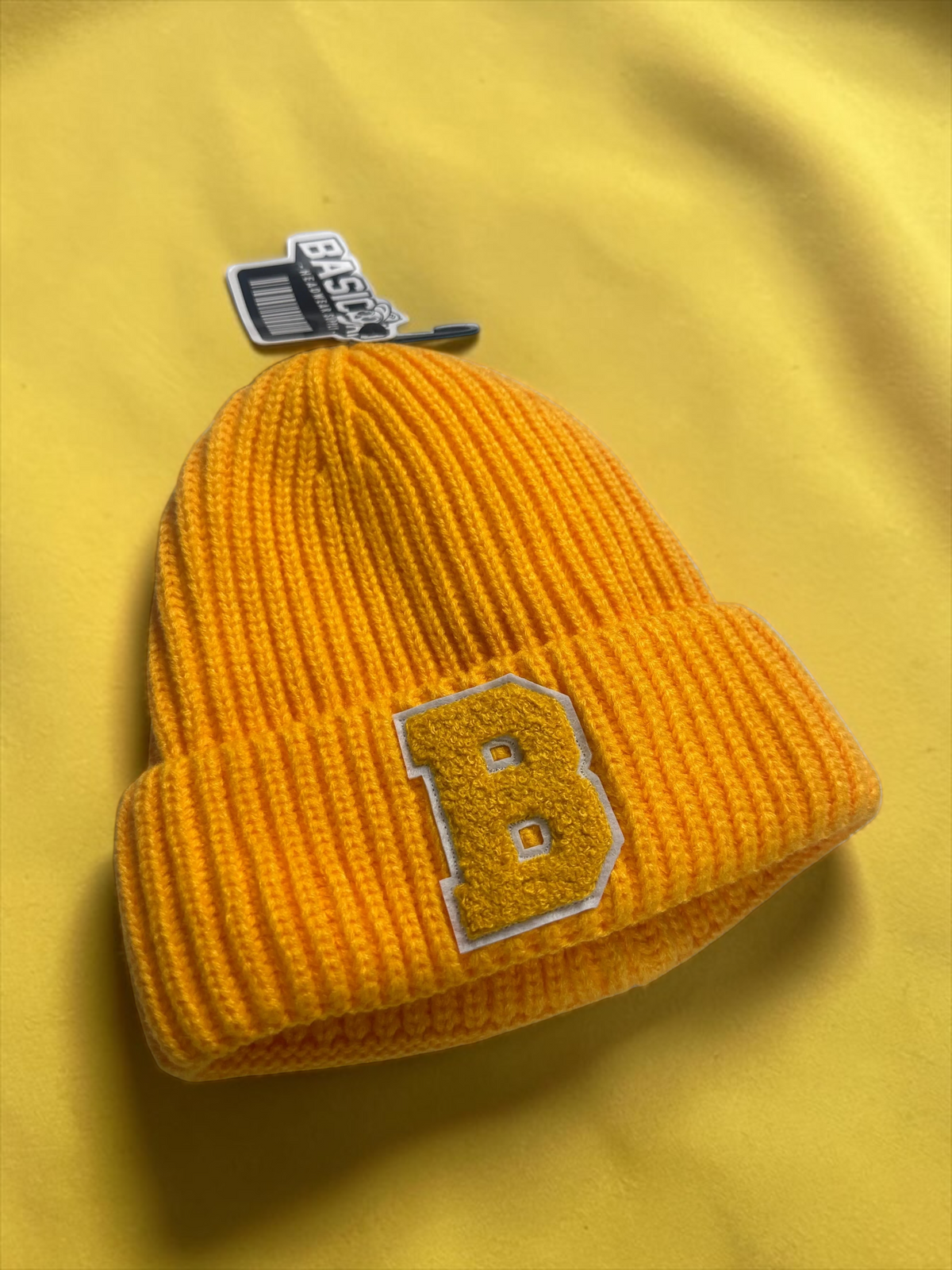 B-Is-TheBrand vibrant yellow ribbed knit beanie with a bold varsity-style letter B patch on the front.
